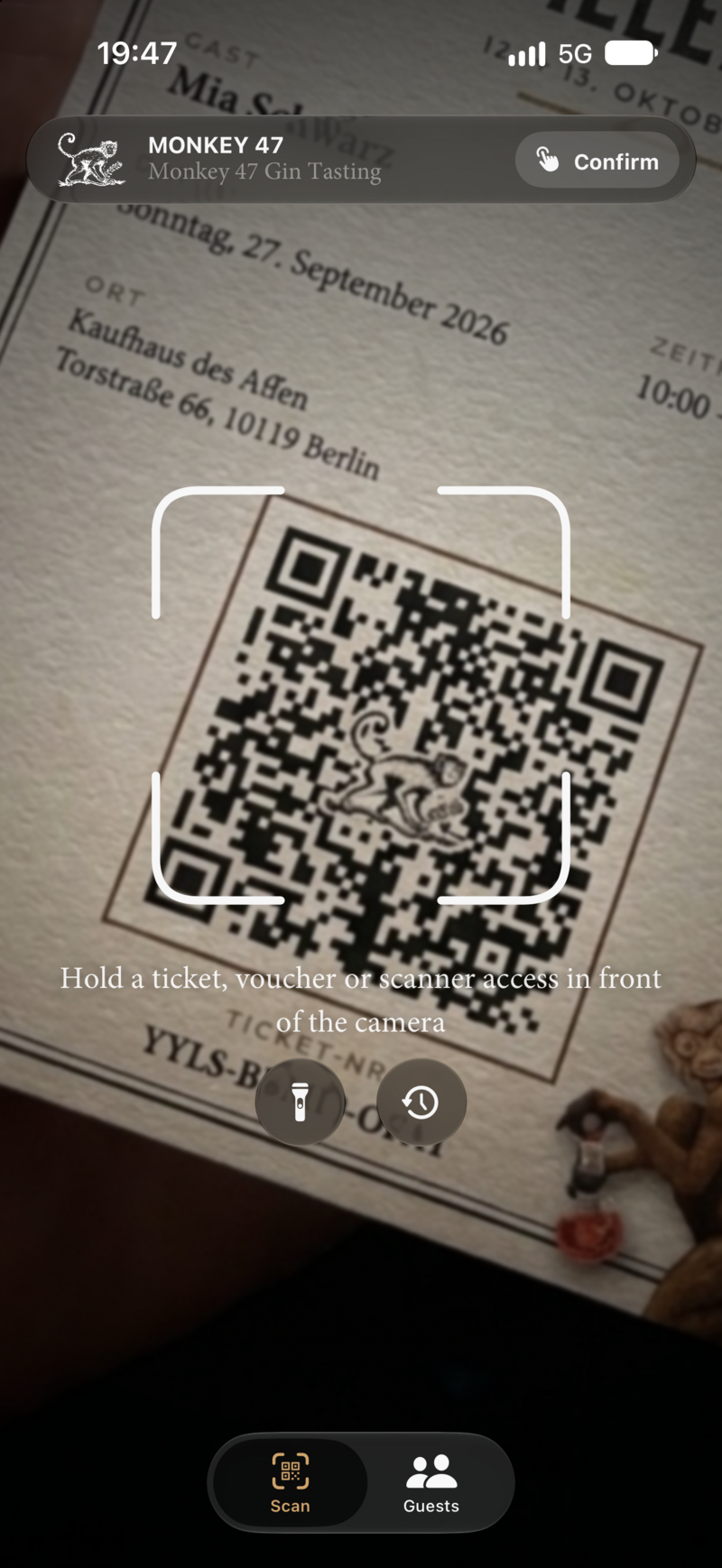 Scanner with a camera view of a ticket and the prompt to hold a ticket, voucher or scanner access in front of the camera.