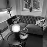 Graues Sofa mit Leuchte und Kuchen in der Büro-Lounge